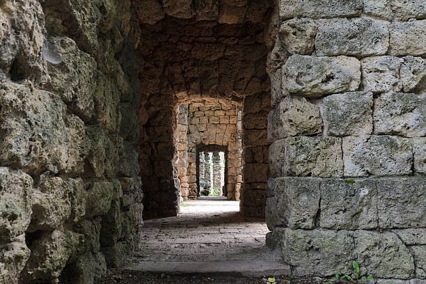 istock Passage carved from rough-hewn stone blocks. 2236672338