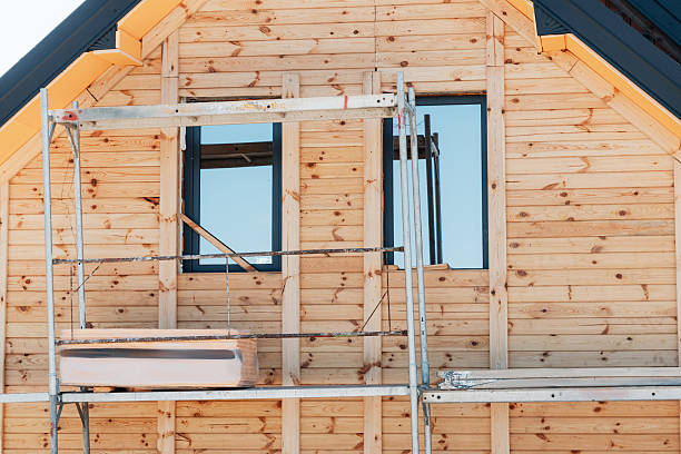 istock Residential building under construction, featuring a natural wood siding facade and scaffolding for ongoing work on the exterior 2236672889