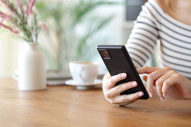 istock Close up of a woman hands using cell phone in a room 2236673596