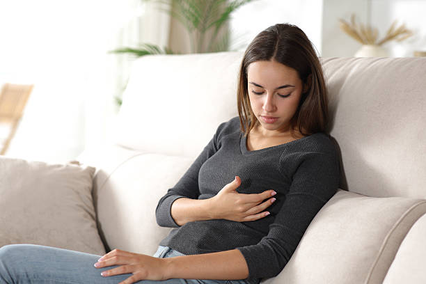 istock Woman at home checking breast 2236673686