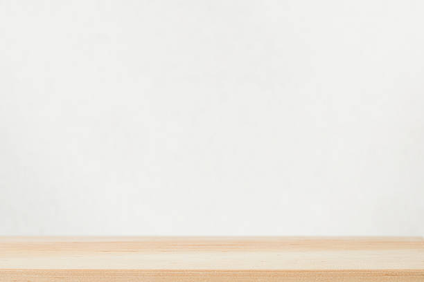 istock Empty light wood table top against gray wall. Design element. Backdrop for your advertising presentation. 2236674471