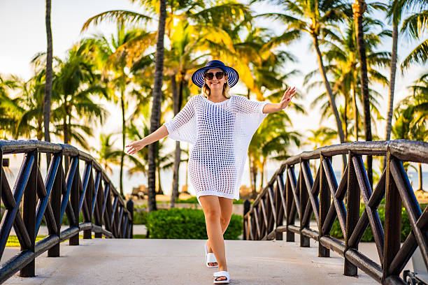Summertime - beautiful woman walking on beach