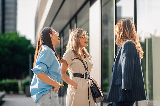 istock Businesswomen talking and walking outside office building 2236675321