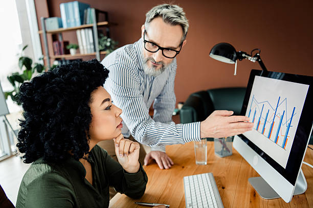 istock Professional colleagues collaborating on a project with analysis and brainstorming in a contemporary office environment 2236677506