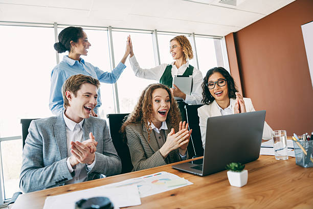istock Team celebrating success while collaborating on a business project in a modern office environment 2236678146
