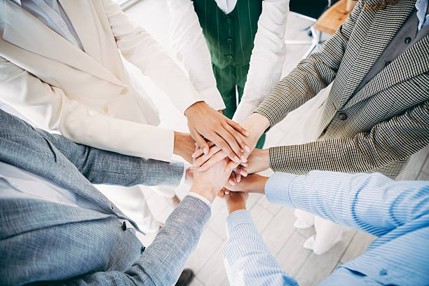 istock Closeup of diverse business professionals stacking hands in unity, symbolizing teamwork, dedication, and collaboration in a workplace 2236678174