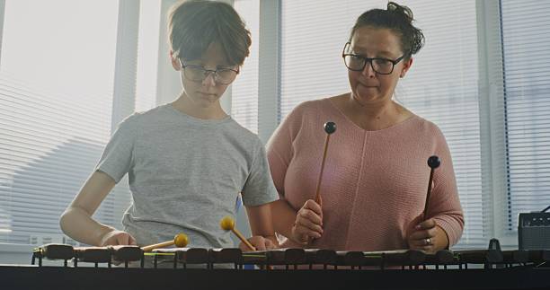 istock Talented Boy Playing Xylophone During Music Lesson. Teacher Teaching Young Musician 2236681005