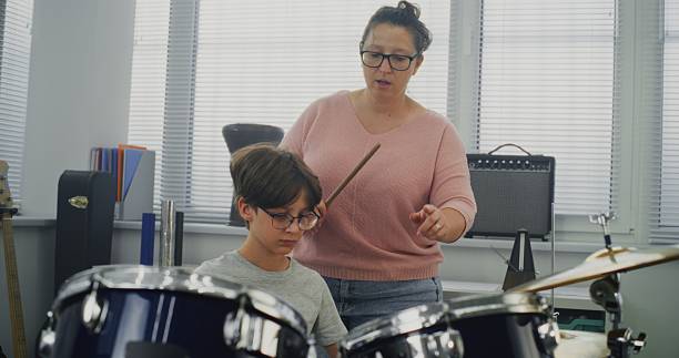 istock Primary School Boy Practicing Sense of Rhythm, Playing Drums in Music Class 2236681614