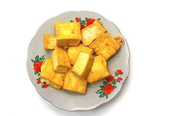 yellow tofu on a plate isolated on a white background, good for recipe, article, menu book, or any cooking contents.