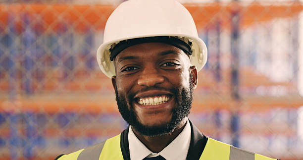 istock Black man, engineer and smile in portrait at construction site with pride, helmet or real estate development. Person, architect and happy for building project, career or property expansion in Kenya 2236684766