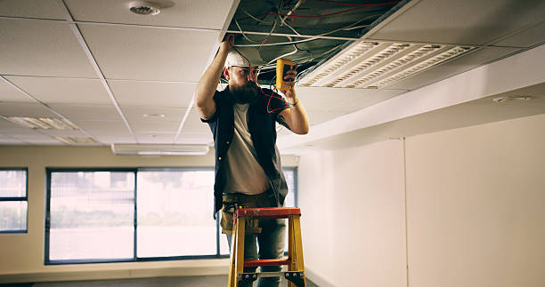istock Electrician, ceiling and man in office with wire, test or safety for quality control. Inspect, maintenance and technician in workplace with multimeter, assessment or voltage read in compliance check. 2236685191