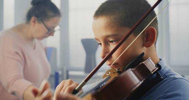 istock Close Up of Talented Boy Playing Violin During Music Lesson. Violin Practice Class 2236685280