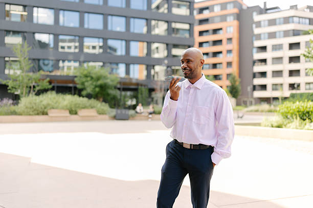 istock Smiling man with phone in modern urban setting 2236694373