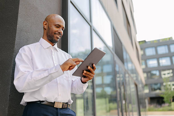 istock Man walking with laptop in modern environment 2236694795