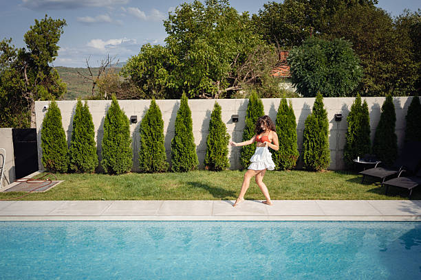 Little girl in an inflatable ring in the swimming pool from above
