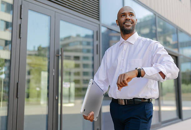 istock Professional man walking with a laptop in hand 2236694875
