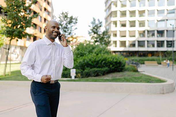 istock Man joyfully walking while on call outdoors 2236694922