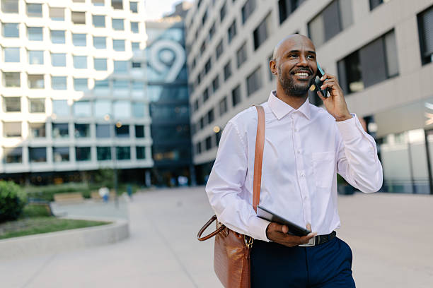istock Man with a bag walking confidently through a city 2236694959