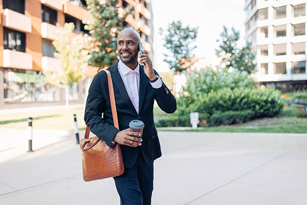 istock Businessman Talking on Phone with Coffee in Hand 2236695011