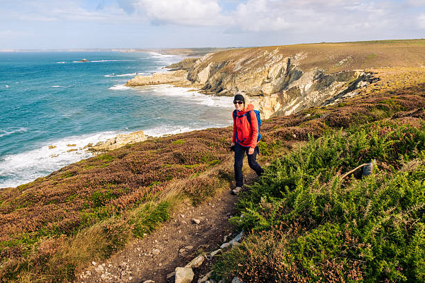 Woman enjoying a hike at Cap de la Chevre in the Brittany region of France.