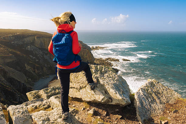 Woman enjoying a hike at Cap de la Chevre in the Brittany region of France.