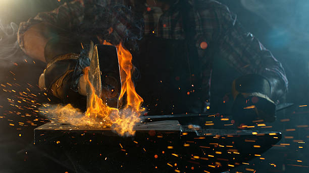 istock Close-up of blacksmith forging glowing hot iron 2236696383