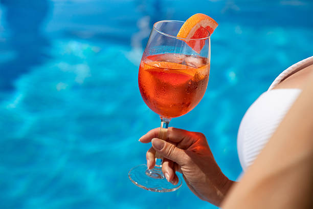 istock Woman in hat relaxing at the pool 2236696473