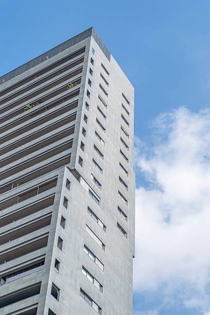 istock Modern High Rise Apartment Building Exterior Low Angle View. Contemporary residential architecture, white facade, urban development tower 2236696607