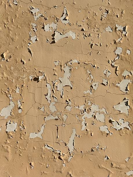 Peeling paint on old weathered wall providing textured abstract background. Mobile photo