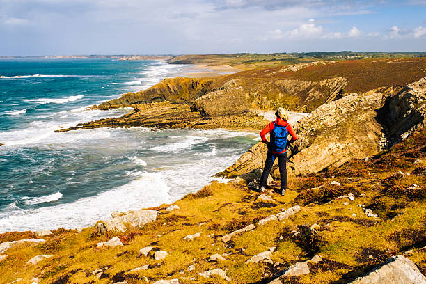 Woman enjoying a hike at Cap de la Chevre in the Brittany region of France.