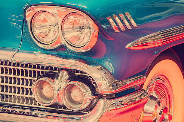 Side front view of a vintage blue classic car with chrome accents