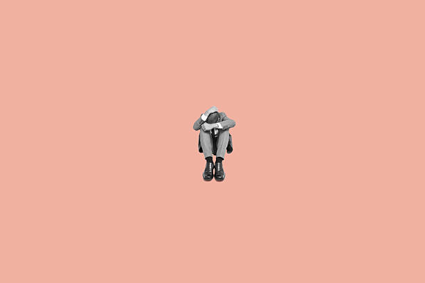 istock sad businessman curled up in the floor 2236699882
