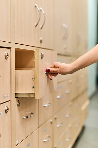 istock Pharmacist accessing medicine cabinet in bright pharmacy environment 2236699913