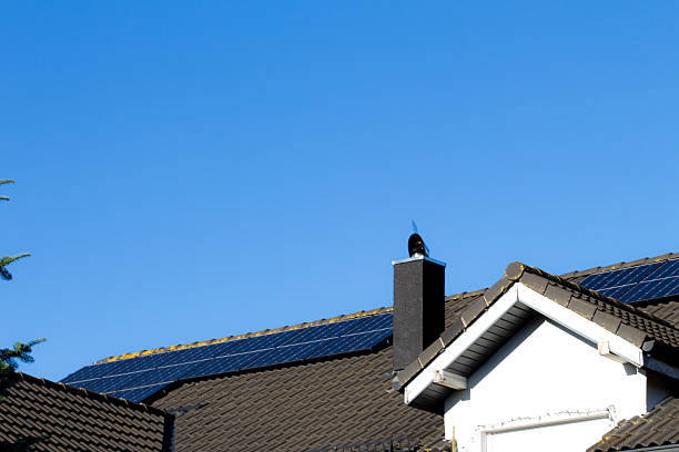 istock Solar panels installed on a residential rooftop under a clear blue sky during bright daylight 2236701427