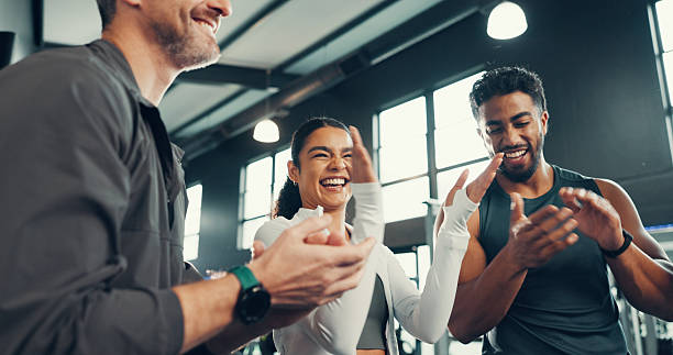 istock Fitness, group and applause with support at gym for exercise progress, training milestone and happy. Sports club, people and celebration for teamwork goals, workout achievement or performance success 2236702566