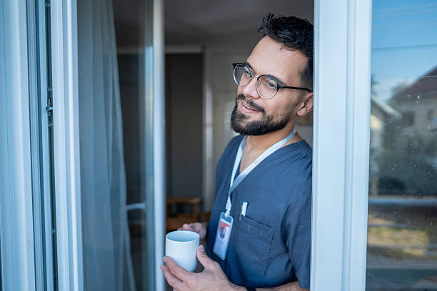 istock Male nurse enjoying coffee break, looking thoughtful 2236708669