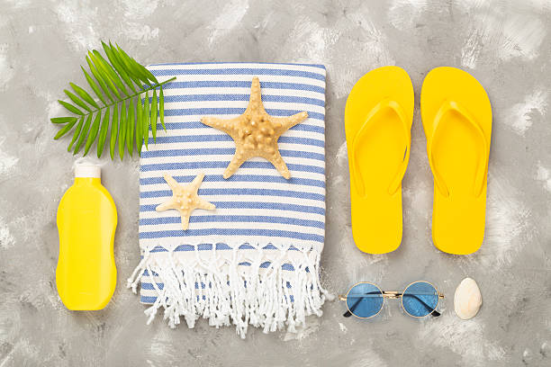 istock Beach towel with summer accessories on concrete background, top view 2236709571