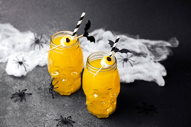 istock Spooky Halloween drinks in skull jars with candy eyes and bat decorations 2236710811