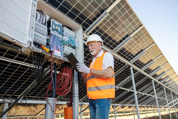 istock Senior Worker with Tablet Inspecting Solar Panel Installation at Industrial Site 2236711609