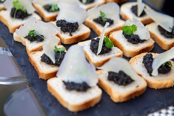 Savoury appetisers on a slate tray at an outdoor party