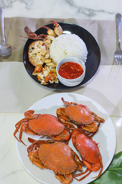 istock Whole Steamed Mud Crabs on a White Plate, and Picked Mud Crabs with Rice and Dipping Sauce on a Black Plate 2236714695