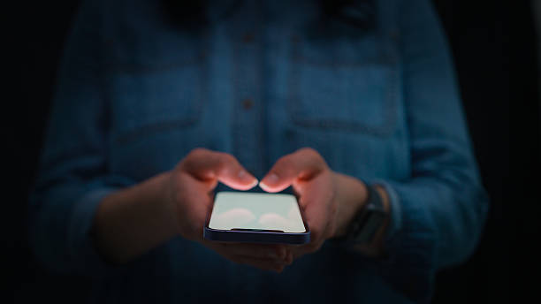 istock Close Up Of Woman Using Mobile Phone Text Messaging Using Thumbs On Keypad 2236715019