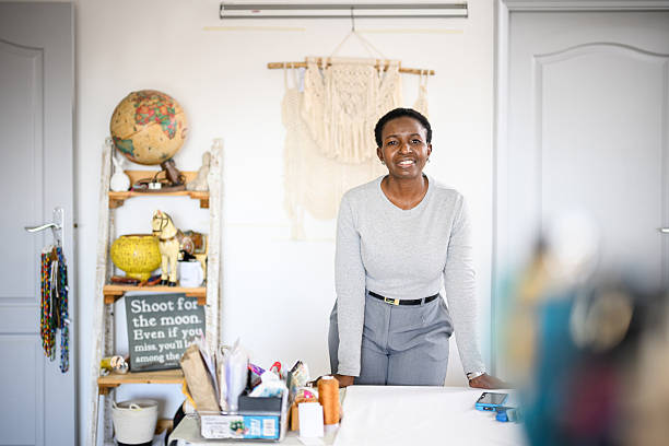 istock Smiling small business owner standing behind counter in artisan studio surrounded by craft materials and handmade decor 2236716778
