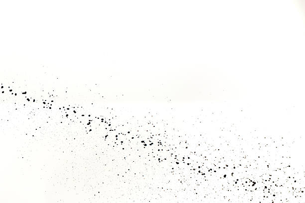 An abstract image showing black and white water splashing particles scattered on a white background, creating a visually striking effect with various shades and textures.