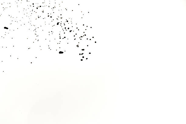 An abstract image showing black and white water splashing particles scattered on a white background, creating a visually striking effect with various shades and textures.