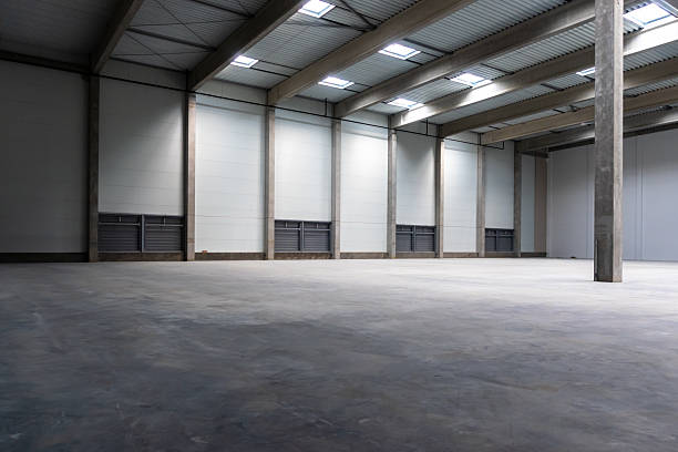 istock The empty interior of a large industrial warehouse. 2236717845