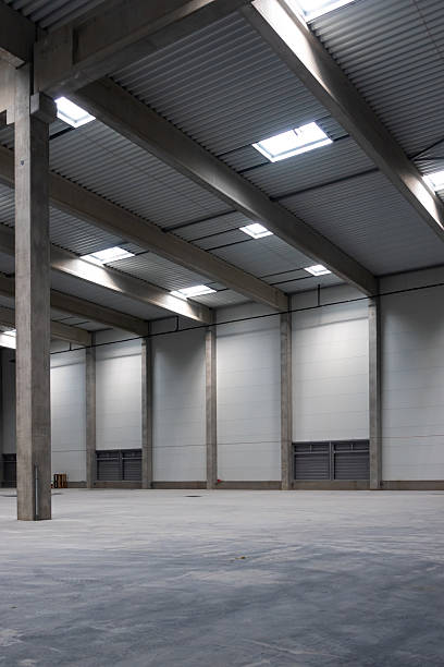istock The empty interior of a large industrial warehouse. 2236717895