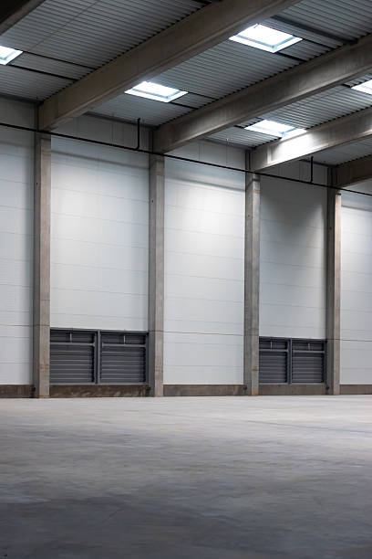 istock The empty interior of a large industrial warehouse. 2236717946
