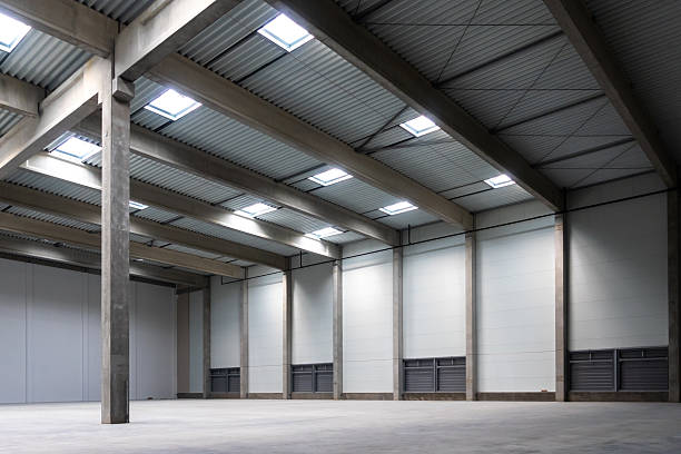 istock The empty interior of a large industrial warehouse. 2236718457