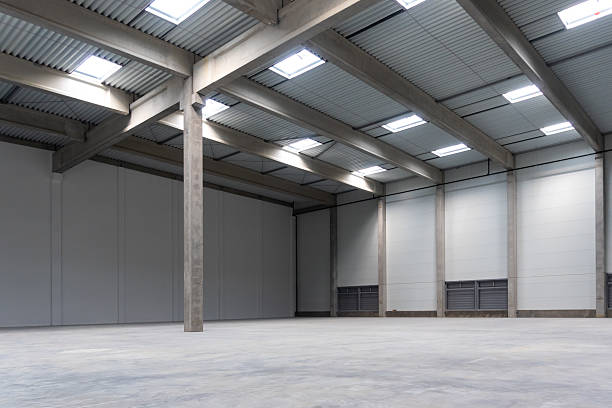 istock The empty interior of a large industrial warehouse. 2236718501